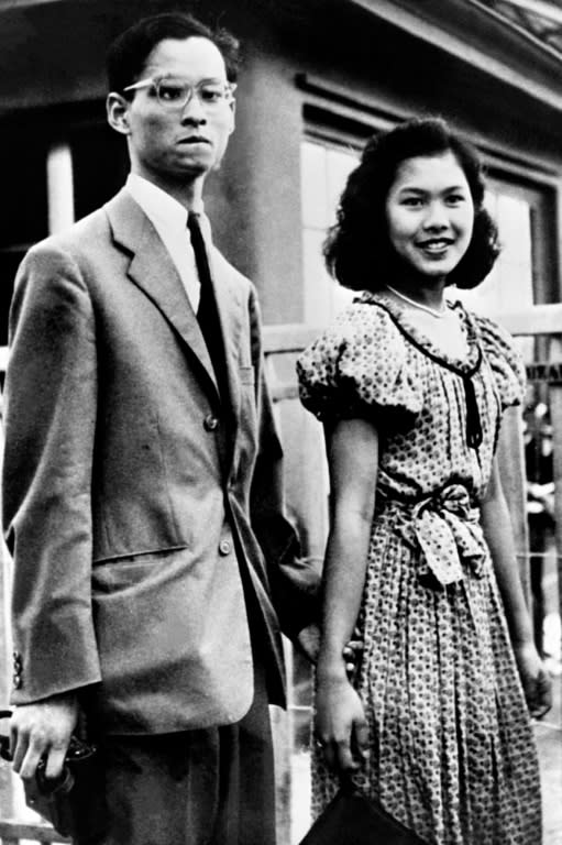 This file photo released in September 1949 shows Sirikit Kitiyakara, then the fiancee, posing next to Bhumibol Adulyadej