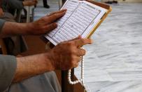 <p>A Palestinian man reads verses of the Quran, Islam’s holy book, during the month of Ramadan at al-Omari mosque in Gaza City, May 29, 2017. (AP Photo/Hatem Moussa) </p>