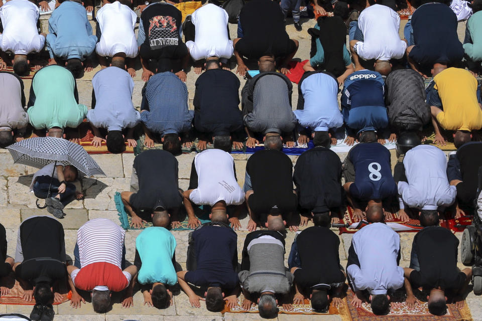 Palestinian worshipers pray during the first Friday of the holy month of Ramadan at the Al Aqsa Mosque compound in Jerusalem's old city, Friday, April. 16, 2021. Tens of thousands of Muslim worshippers have gathered at a sacred Jerusalem plaza for the first Friday prayers of Ramadan after coronavirus lockdowns kept the site off-limits last year. About 70,000 faithful, most of them Arab citizens of Israel, prayed in al-Aqsa mosque, the third holiest site in Islam. (AP Photo/Mahmoud Illean)