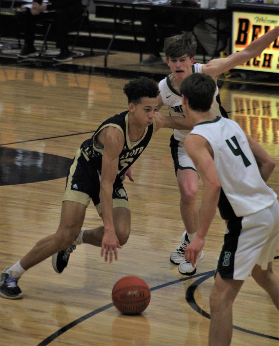 Lloyd Memorial junior Jeremiah Israel drives against Brossart junior Logan Woosley as Lloyd defeated Bishop Brossart 58-43 during the Mike Swauger Holiday Classic boys basketball tournament at Ben Flora Gymnasium, Bellevue, Ky.