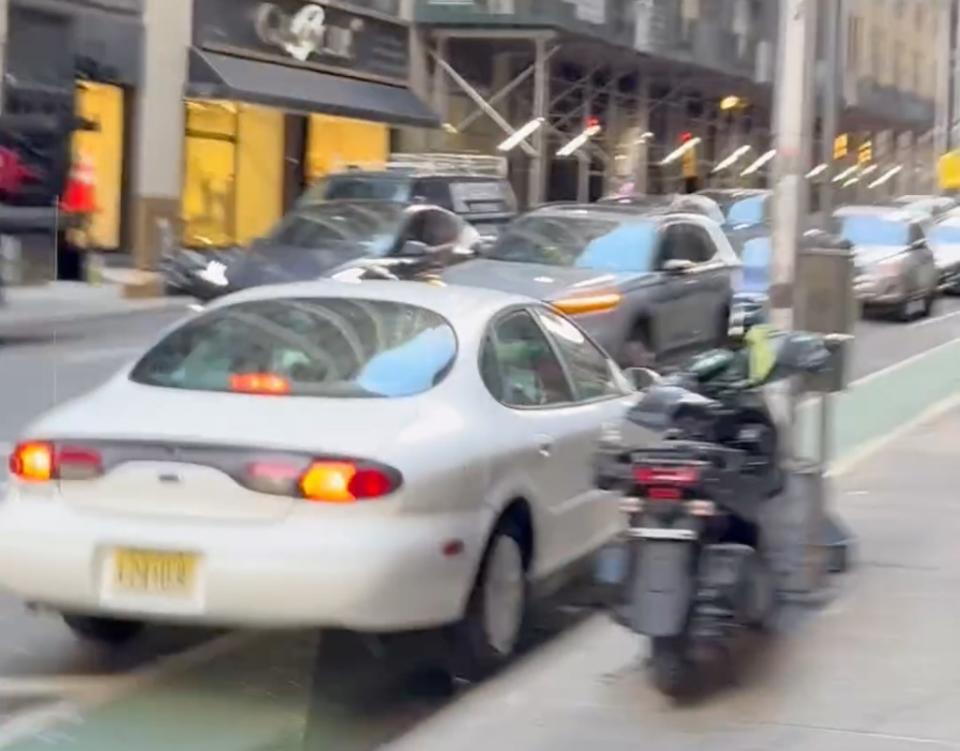 At one point, the enraged driver plowed down a bike lane on West 39th Street before mounting the sidewalk again. WhatIsNewYork/Instagram