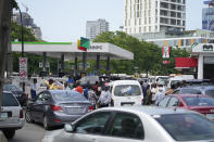 People queue to buy fuel at the Nigerian National Petroleum Company Limited petrol station in Lagos, Nigeria, Tuesday, May 30, 2023. Nigerian President Bola Tinubu has scrapped a decadeslong government-funded subsidy that has helped reduce the price of gasoline, leading to long lines at fuel stations Tuesday as drivers scrambled to stock up before costs rise. (AP Photo/Sunday Alamba)
