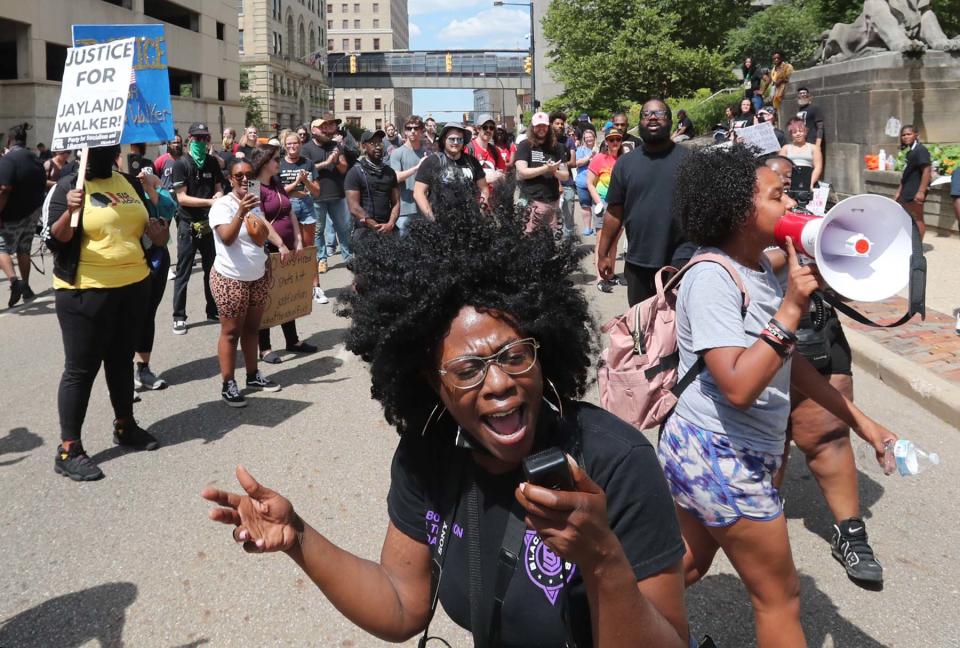 Ashley Dorelus of California leads a chant of  "I love being Black" on Saturday at a protest organized by the Party for Socialism and Liberation in front of the Summit County Courthouse in Akron.