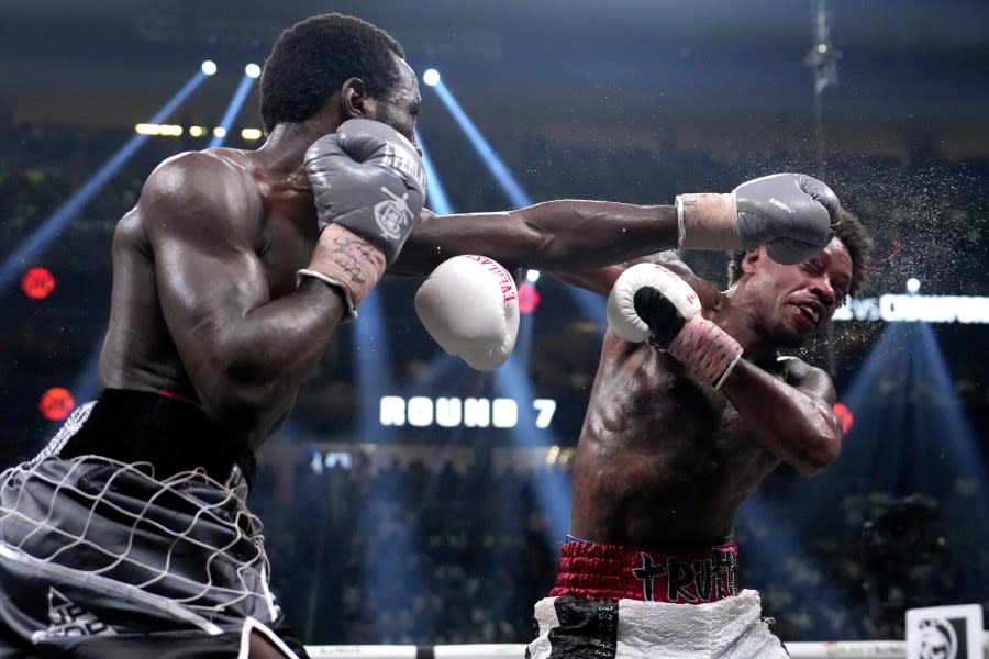 Terence Crawford, left, hits Errol Spence Jr. during their undisputed welterweight championship boxing match, Saturday, July 29, 2023, in Las Vegas. (AP Photo/John Locher)