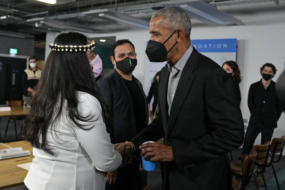 Former U.S. President Barack Obama greets Sheila Babauta, a member of the Northern Mariana Islands House of Representatives, ahead of a roundtable meeting at the COP26 U.N. Climate Summit in Glasgow, Scotland, Monday, Nov. 8, 2021. The U.N. climate summit in Glasgow gathers leaders from around the world, in Scotland's biggest city, to lay out their vision for addressing the common challenge of global warming. (AP Photo/Alastair Grant)