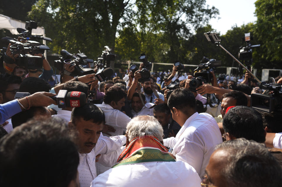 Media personnel surround newly elected president of India’s main opposition Congress party Mallikarjun Kharge, back to camera after the election results, in New Delhi, India, Wednesday, Oct. 19, 2022. Kharge was elected new president in a contest in which the Nehru-Gandhi family, which has led the party for more than two decades, did not compete. (AP Photo/Manish Swarup)