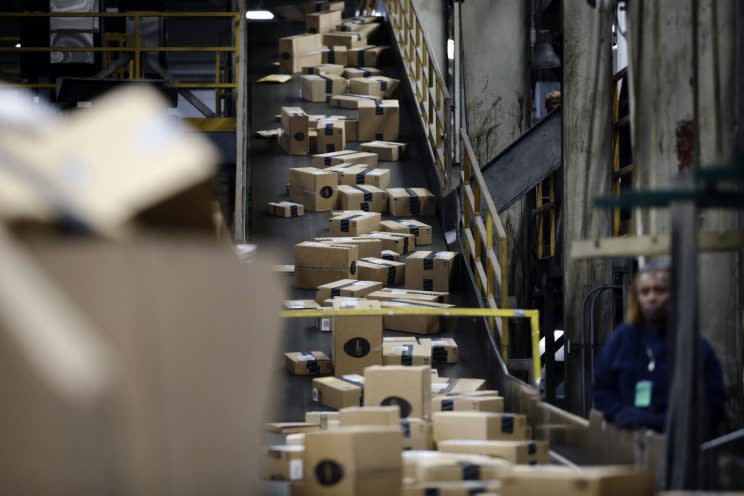 In this Monday, Dec. 2, 2013 photo, FedEx Packages move on a conveyor belt at the FedEx hub at Los Angeles International Airport in Los Angeles. Hiring usually gets a boost with the advent of holiday shopping, but online shopping has changed where people are hiring. Transportation and warehouse jobs in places like FedEX and UPS jumped 30,500 in November. That’s 50 percent greater than the November 2012 increase. (AP Photo/Jae C. Hong) 