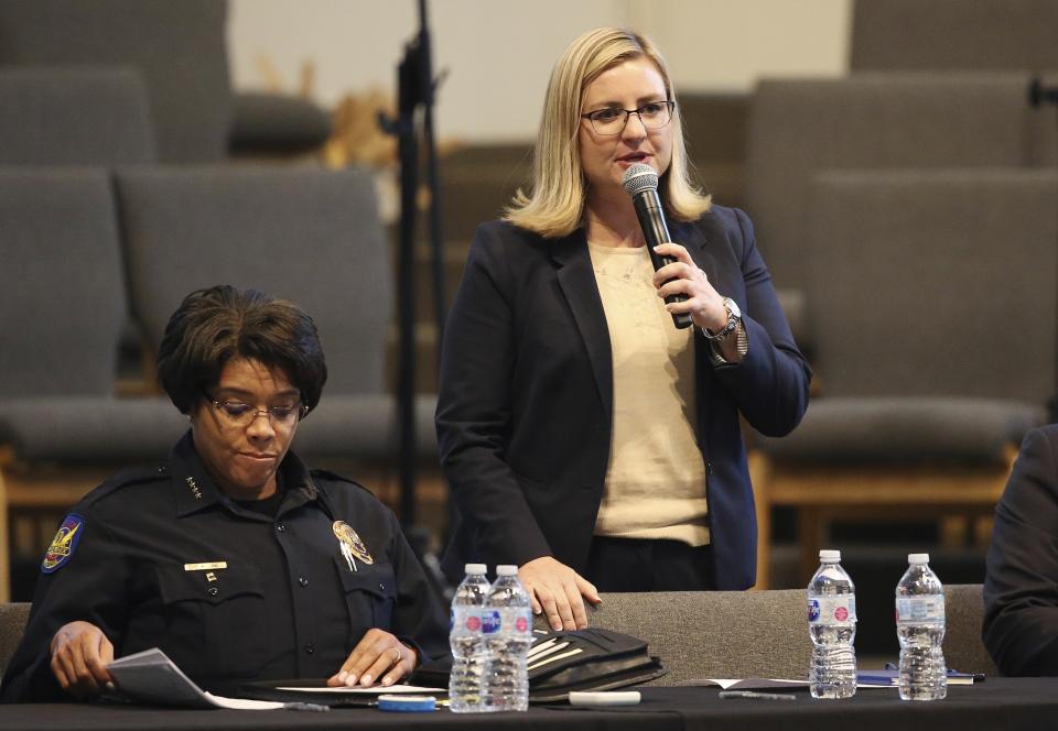 Phoenix Mayor Kate Gallego, right, addresses the audience as Phoenix Police Chief Jeri Williams, left, goes through notes at a community meeting, Tuesday, June 18, 2019, in Phoenix. The community meeting stems from reaction to a videotaped encounter that surfaced recently of Dravon Ames and his pregnant fiancee, Iesha Harper, having had guns aimed at them by Phoenix police during a response to a shoplifting report, as well as the issue of recent police-involved shootings in the community. (AP Photo/Ross D. Franklin)