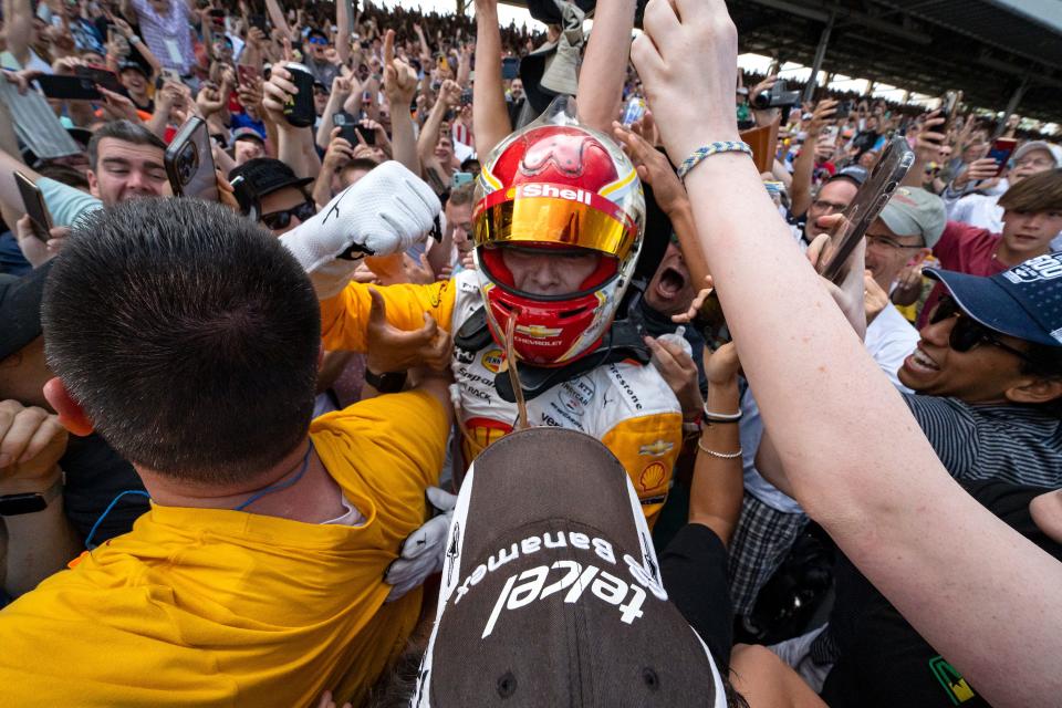 Team Penske driver Josef Newgarden (2) celebrates with fans Sunday, May 28, 2023, after winning the 107th running of the Indianapolis 500 at Indianapolis Motor Speedway.