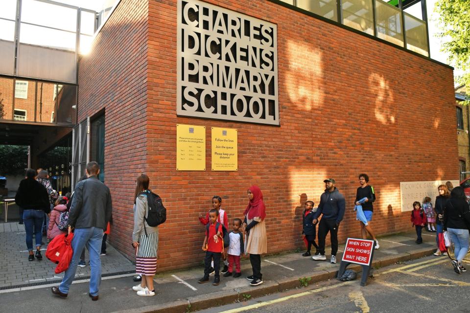 Children queuing up for school at the beginning of a new school year (PA)