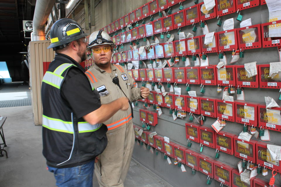 This Sept. 20, 2022 image shows workers at the San Juan Generating Station near Waterflow, New Mexico, using a lock box system before checking out tools. The closure of the coal-fired power plant and the adjacent mine is resulting in the loss of hundreds of jobs and tax revenue that supports a local school district where nearly 93% of students are Native American. (AP Photo/Susan Montoya Bryan)