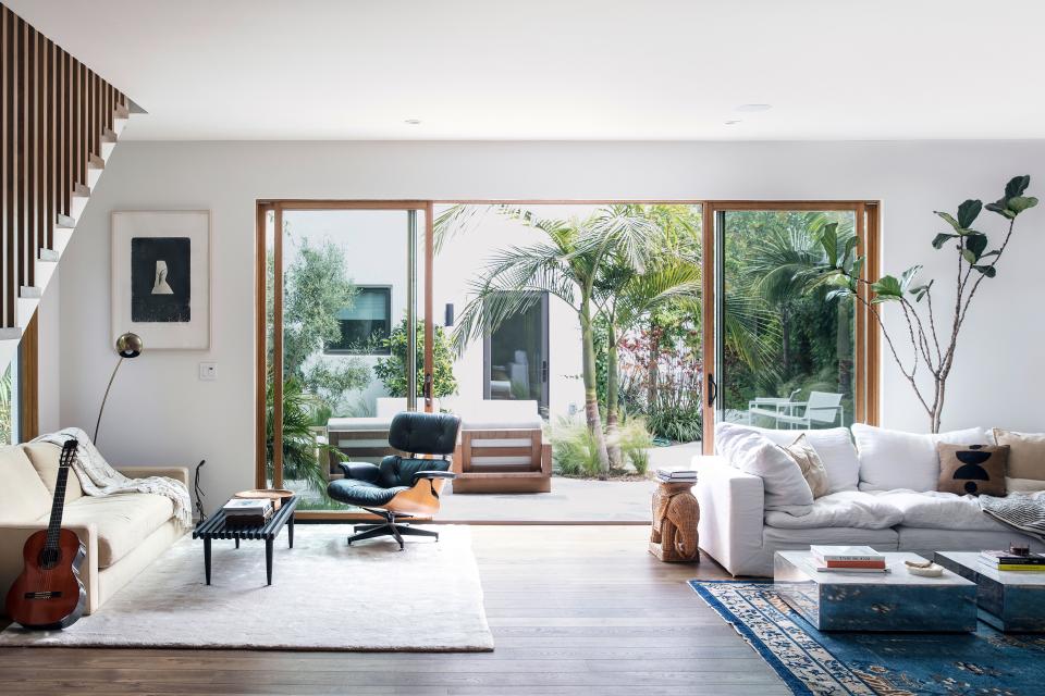 Noah Mills's living room opens up to the pièce de résistance of the home: the backyard.