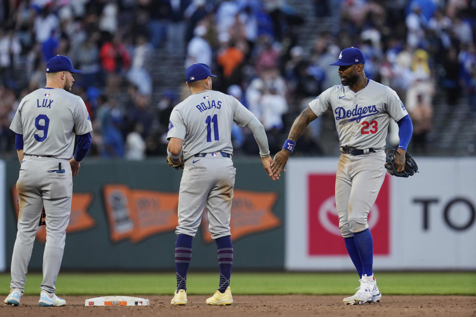 Los Angeles Dodgers right fielder Jason Heyward, right, celebrates with shortstop Miguel Rojas (11) after the team's victory over the San Francisco Giants in a baseball game Saturday, June 29, 2024, in San Francisco. (AP Photo/Godofredo A. Vásquez)