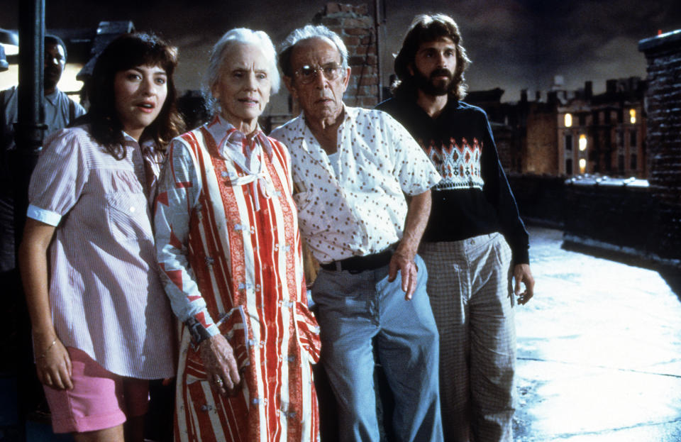 Frank McRae, Elizabeth Pe–a, Jessica Tandy, Hume Cronyn, and Dennis Boutsikaris standing out on roof in scene from the film '*Batteries Not Included', 1987. (Photo by Universal/Getty Images)