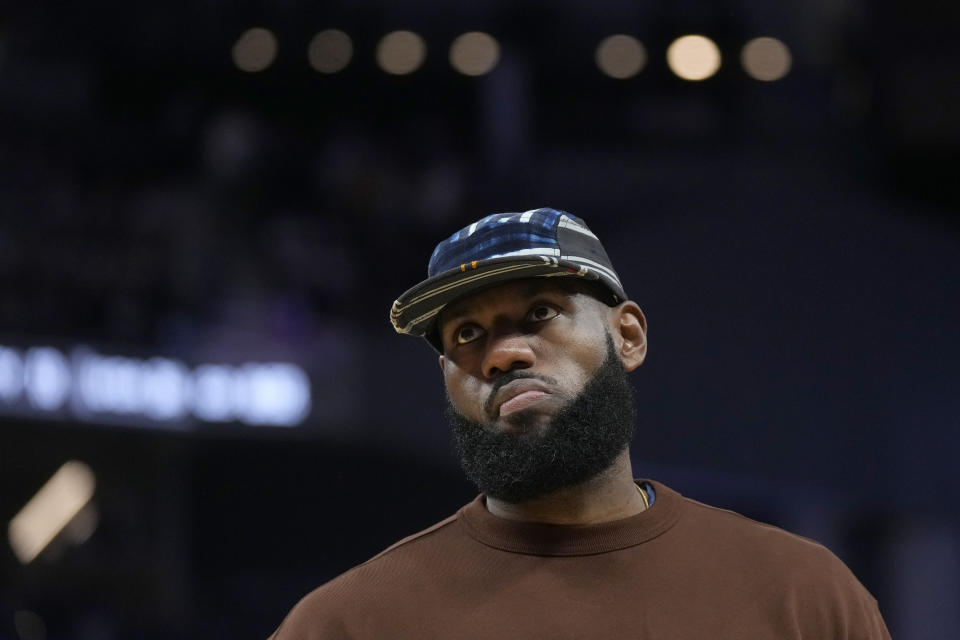 LeBron James of the Los Angeles Lakers stands during a timeout during the first half of an NBA preseason basketball game against the Golden State Warriors in San Francisco, Saturday, Oct. 7, 2023.  (AP Photo/Jeff Chiu)