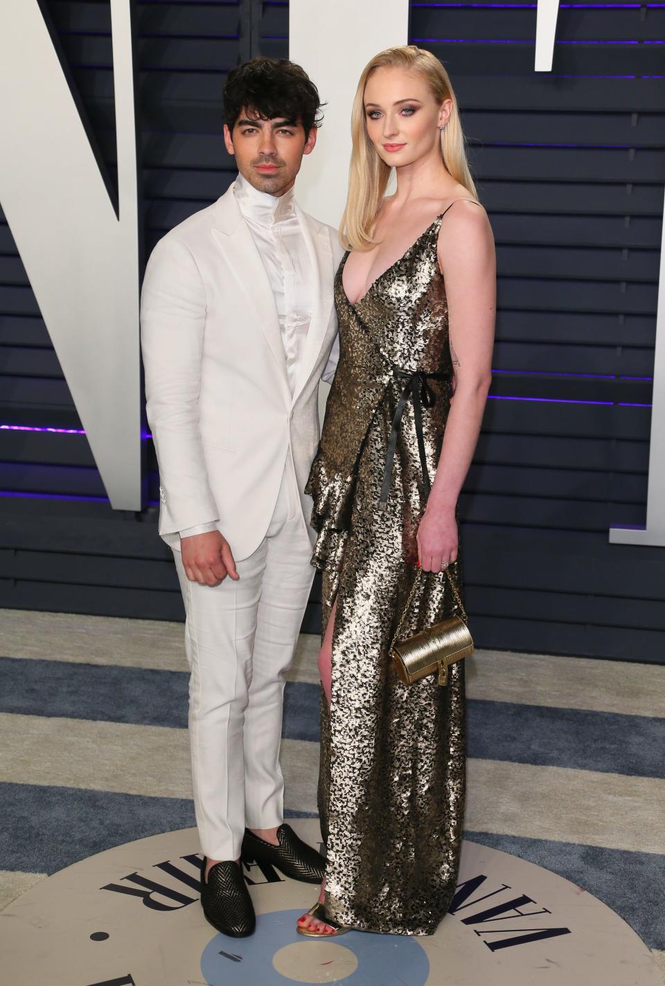 <p>Joe trägt einen Smoking ganz in Weiß, während Sophie ein metallic-schimmerndes Wickelkleid anhat. <em>[Foto: Getty]</em> </p>