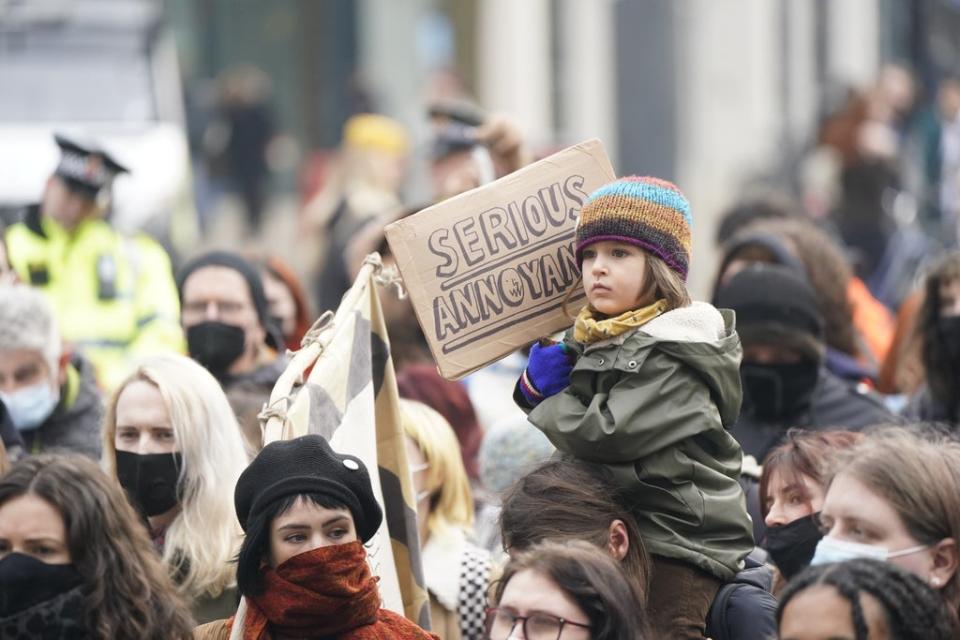 A young child is given a shoulder ride in Manchester (Danny Lawson/PA) (PA Wire)