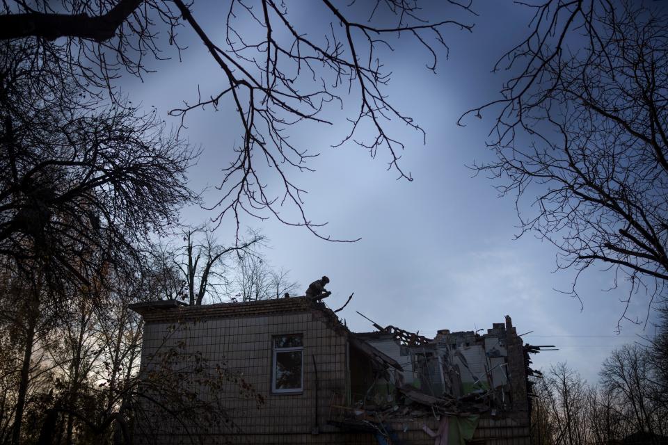 A Ukrainian serviceman stands atop a damaged kindergarten following a Russian drone attack in Kyiv (Copyright 2023 The Associated Press. All rights reserved.)