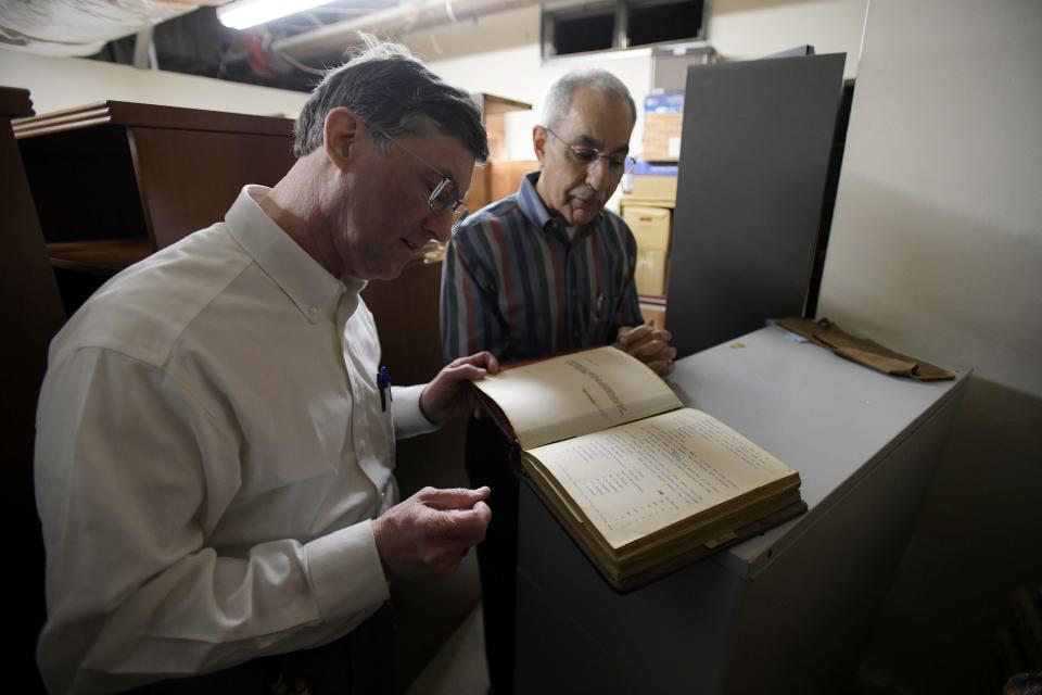 Jeff Clements, the chief of research for Jacksonville's City Council, and Council President Ron Salem look over one of the many historic records currently stored in the basement of Jacksonville's City Hall building.