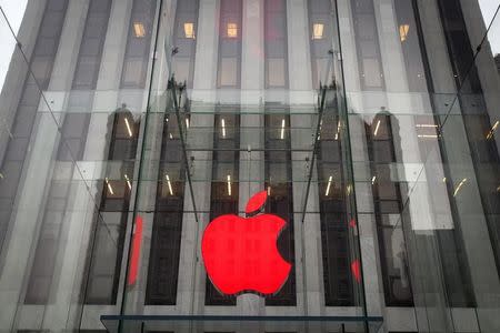 The Apple logo is illuminated in red at the Apple Store on 5th Avenue to mark World AIDS Day, in the Manhattan borough of New York December 1, 2014. REUTERS/Carlo Allegri/Files