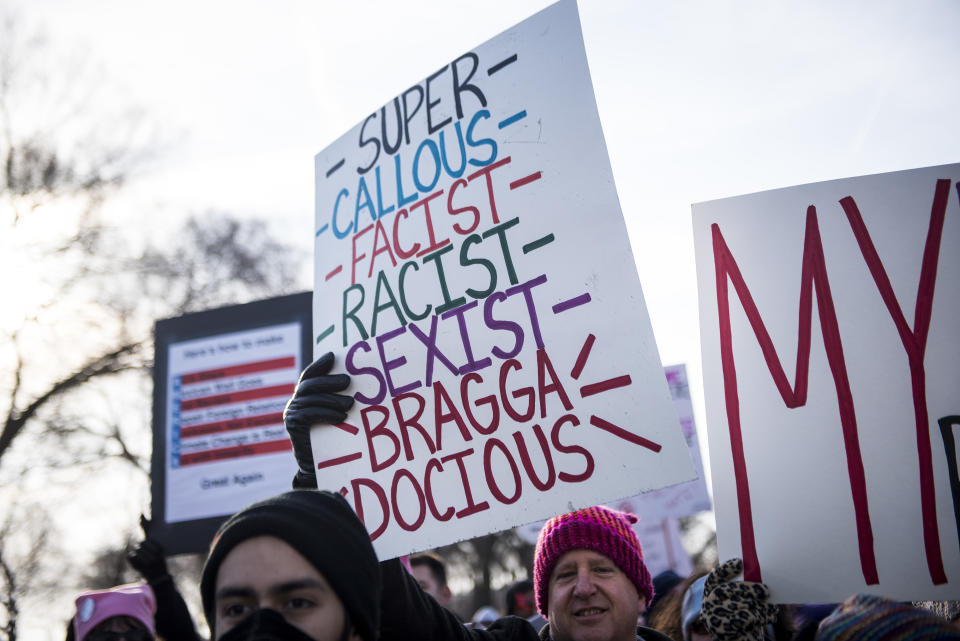 <p>Demonstrators hold signs during the second annual Women’s March in Chicago, Ill., on Saturday, Jan. 20, 2018. (Photo: Christopher Dilts/Bloomberg via Getty Images) </p>