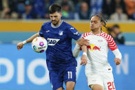 Hoffenheim's Florian Grillitsch, left, and Leipzig's Xavi Simons battle for the ball during the Bundesliga soccer match between TSG 1899 Hoffenheim and RB Leipzig at PreZero Arena, Sinsheim, Germany, Friday May 3, 2024. (Uwe Anspach/dpa via AP)