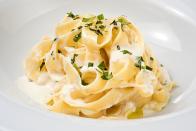 <p>If you're a huge fan of Olive Garden's Alfredo sauce, you'll definitely want to keep reading, because employees have shared how it's made. A former server and bartender spilled the secret in a <a href="https://www.reddit.com/r/IAmA/comments/2gm2ik/iama_former_olive_garden_bartenderserver_ama/ckku702/" rel="nofollow noopener" target="_blank" data-ylk="slk:Reddit AMA;elm:context_link;itc:0;sec:content-canvas" class="link ">Reddit AMA</a>, saying, "Its garlic, butter, heavy cream, and Parmesan cheese. Just make sure to simmer the cream, don't boil it or the cheese will curdle, and add the cheese a little bit at a time while stirring." </p>