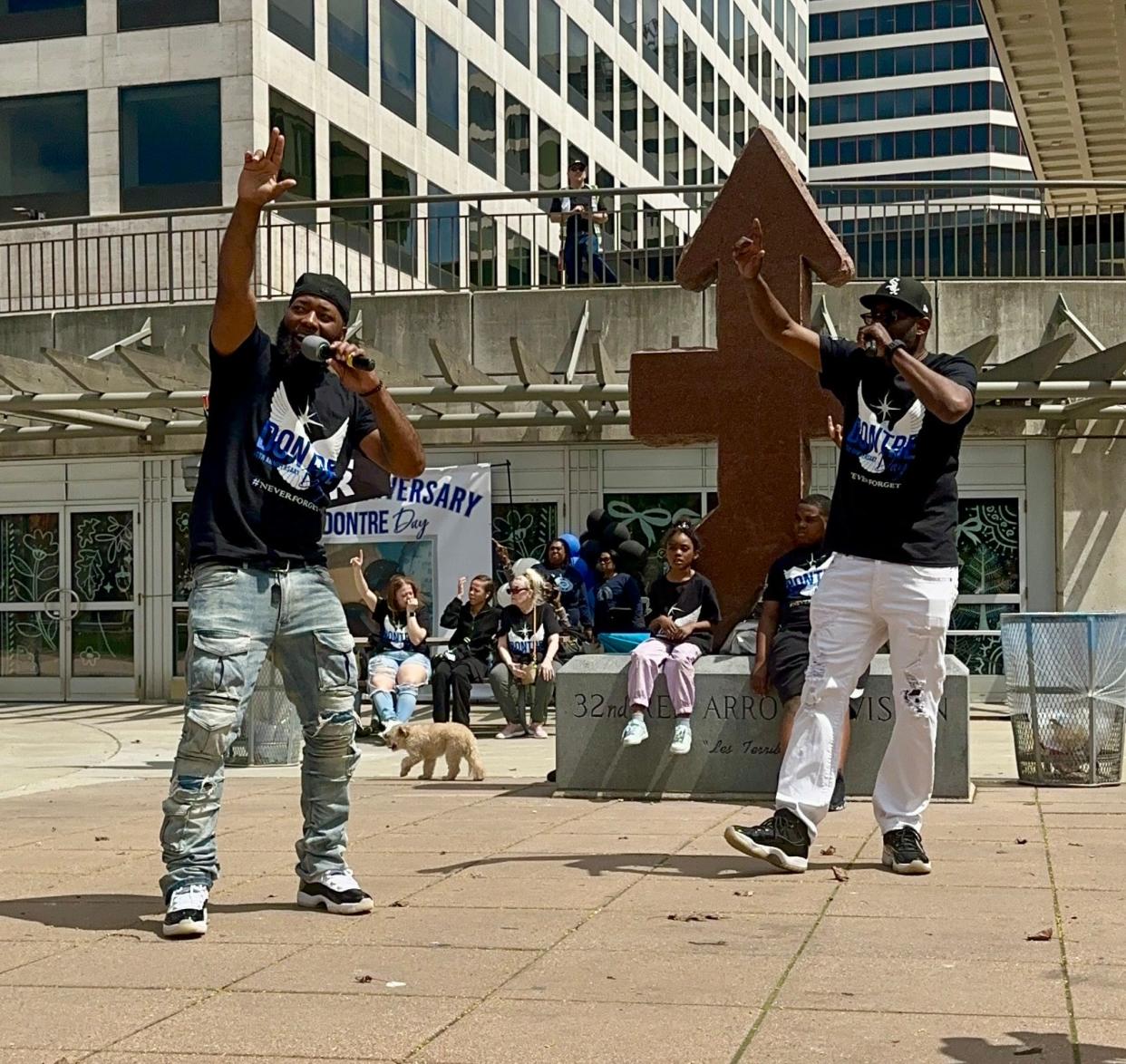 Dontre Hamilton's brothers, Dameion Perkins, left, and Nate Hamilton, perform the song "One Love," written in his honor, on Saturday in Red Arrow Park where supporters marked the 10th anniversary of Dontre's death.