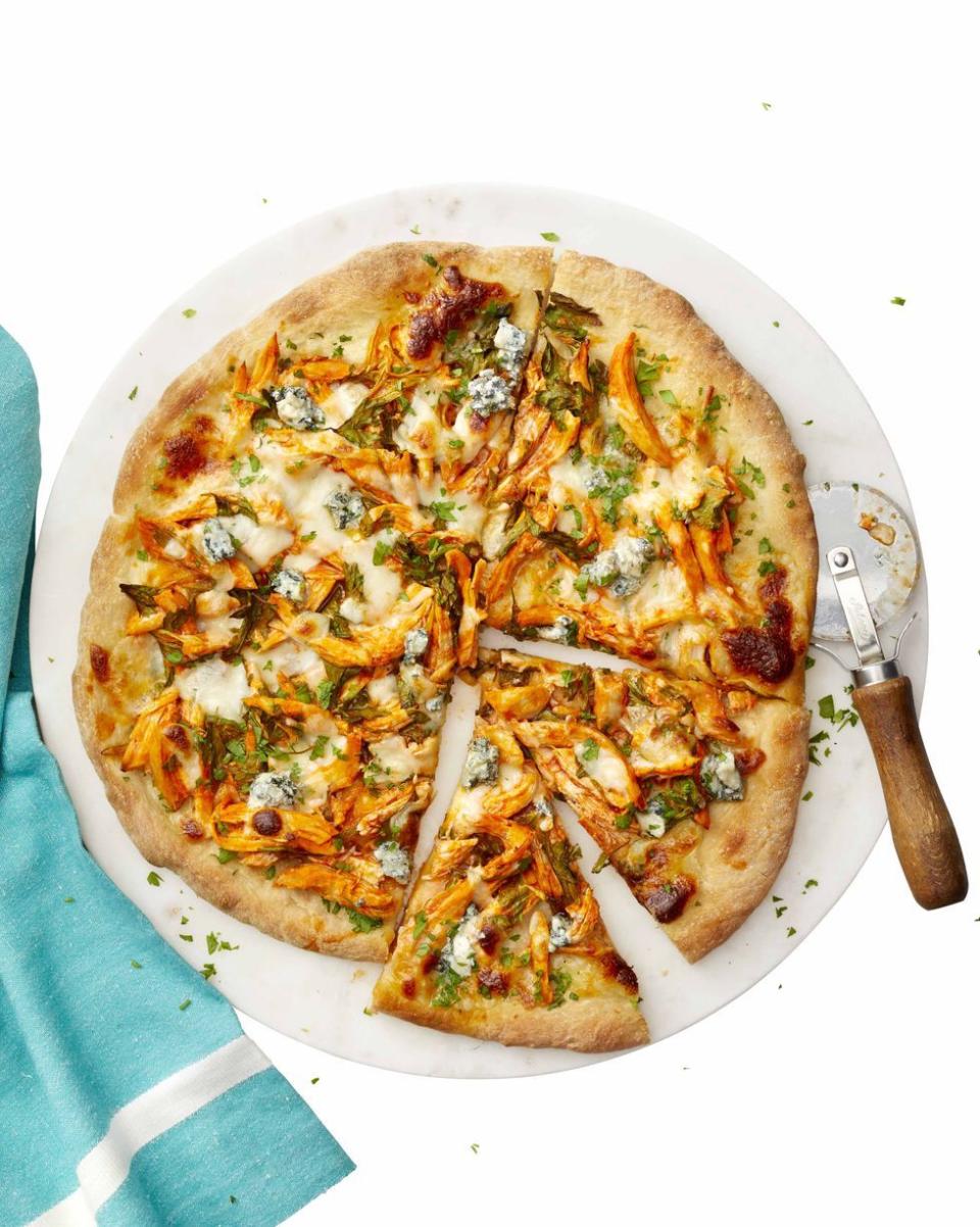 <p>This mouthwatering buffalo chicken pizza puts a lighter spin on a classic fried-food favorite. Made with cayenne pepper sauce and crumbled blue cheese, this pizza only takes 40 minutes to total time. </p><p><a href="https://www.womansday.com/food-recipes/a25692226/buffalo-chicken-pizza-recipe/" rel="nofollow noopener" target="_blank" data-ylk="slk:Get the Buffalo Chicken Pizza recipe.;elm:context_link;itc:0;sec:content-canvas" class="link "><em>G</em><em>et the Buffalo Chicken Pizza recipe.</em></a></p>