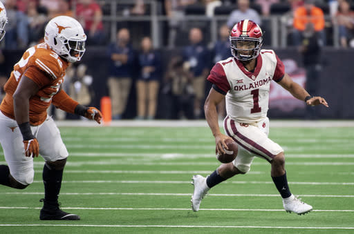 Oklahoma quarterback Kyler Murray (1) scrambles away from Texas defensive lineman Malcolm Roach (32) during the first half of the Big 12 Conference championship NCAA college football game on Saturday, Dec. 1, 2018, in Arlington, Texas. (AP Photo/Jeffrey McWhorter)