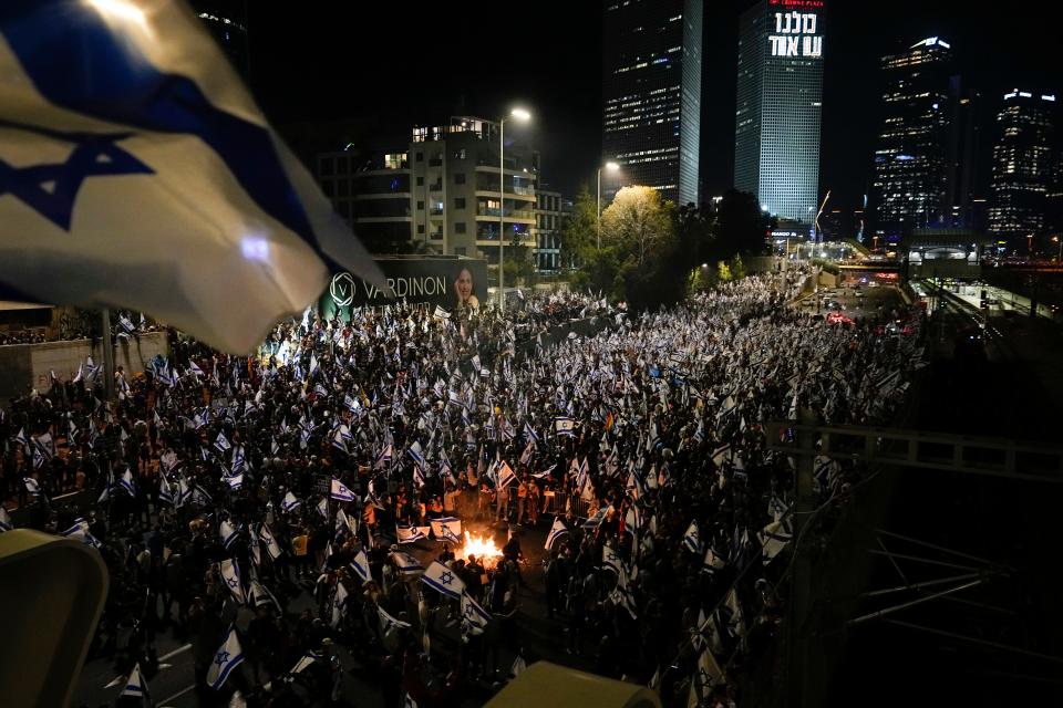 Israelis protest moments after the Israeli leader fired his defense minister, in Tel Aviv, Israel, Sunday, March 26, 2023.
