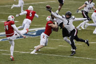 Cincinnati's Wilson Huber (2) deflects the ball as he gets a hand on the punt of Louisville's Mark Vassett (49) during the first quarter of the Fenway Bowl NCAA college football game at Fenway Park Saturday, Dec. 17, 2022, in Boston. (AP Photo/Winslow Townson)