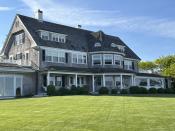 A home sits on a freshly mowed lawn in Edgartown, Mass., Tuesday, June 4, 2024. High housing costs on Martha's Vineyard are forcing many regular workers to leave and are threatening public safety. (AP Photo/Nick Perry)