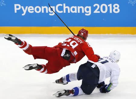 Ice Hockey – Pyeongchang 2018 Winter Olympics – Men Preliminary Round Match – Olympic Athletes from Russia v Slovenia - Gangneung Hockey Centre, Gangneung, South Korea – February 16, 2018 - Ilya Kablukov, an Olympic Athlete from Russia, and Bostjan Golicic of Slovenia compete. REUTERS/Grigory Dukor