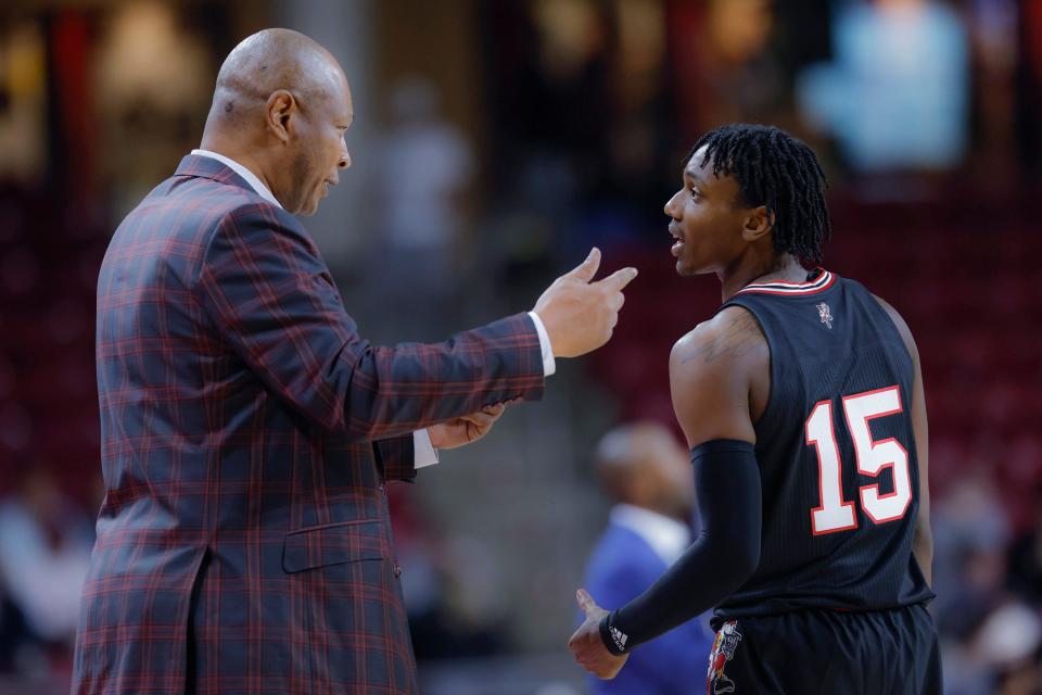 Louisville coach Kenny Payne talks with guard Hercy Miller (15) during the second half of the team's NCAA college basketball game against Boston College, Wednesday, Jan. 25, 2023, in Boston. (AP Photo/Greg M. Cooper)