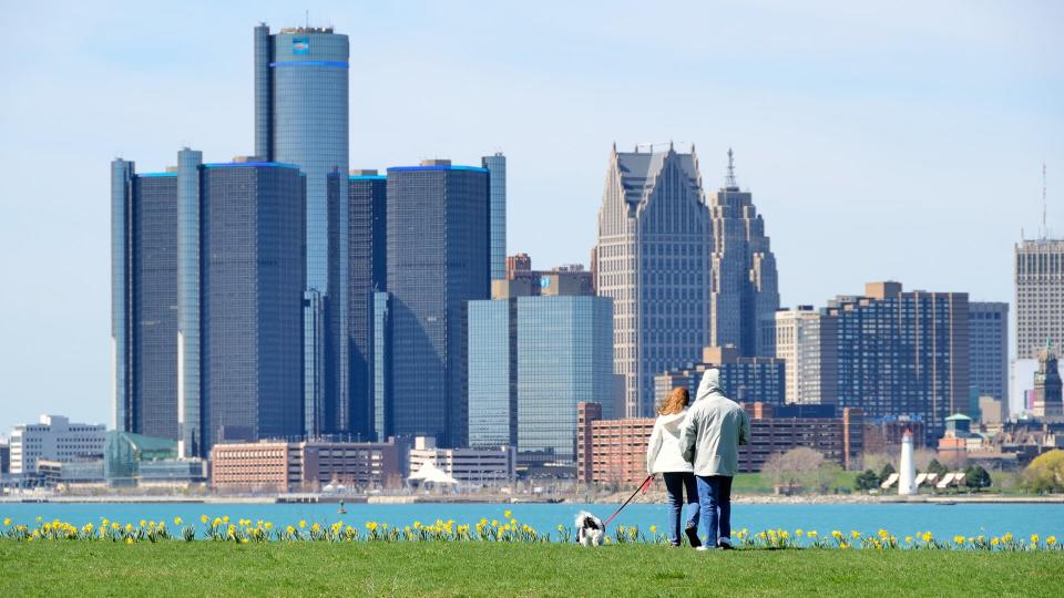 "Detroit, Michigan, USA - April 4, 2012: People walking their dog on a sunny day on Belle Isle, a city park in the Detroit River.