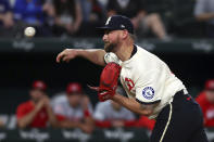 Texas Rangers pitcher Kirby Yates delivers during the ninth inning against the Cincinnati Reds in a baseball game Friday, April 26, 2024, in Arlington, Texas. (AP Photo/Richard W. Rodriguez)