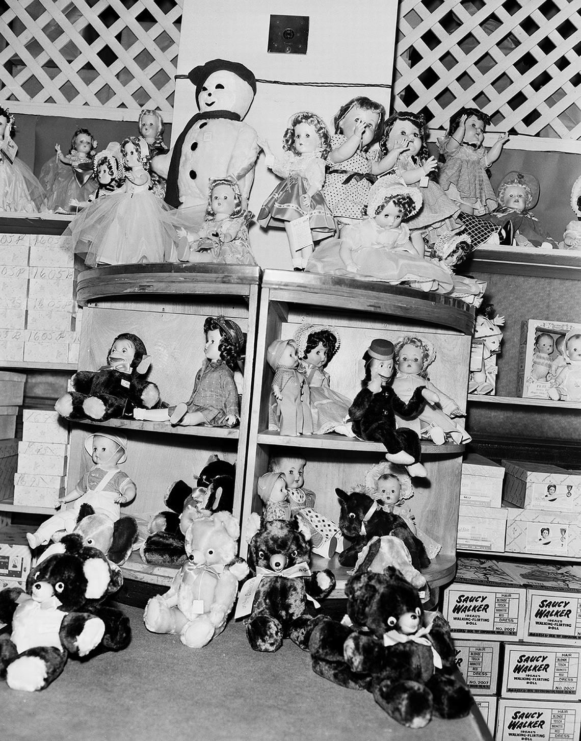 Nov. 18, 1953: “What little girl would find it easy to decide what to ask from Santa when she enters Toyland to be surrounded with shelves of dolls? Would she want a pretty doll to dress up and love, a pert monkey, cuddly bear or great white snowman with red stocking cap?” Leonard’s Department Store.