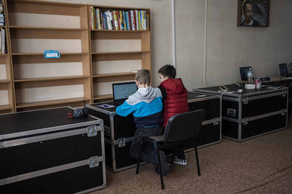 Internally displaced children from Kharkiv and Kyiv connect to an online class in Lviv, western Ukraine, Monday, March 14, 2022. Overnight, air raid alerts sounded in cities and towns around the country, from near the Russian border in the east to the Carpathian Mountains in the west, and fighting continued on the outskirts of Kyiv. Ukrainian officials said Russian forces shelled several suburbs of the capital. (AP Photo/Bernat Armangue)