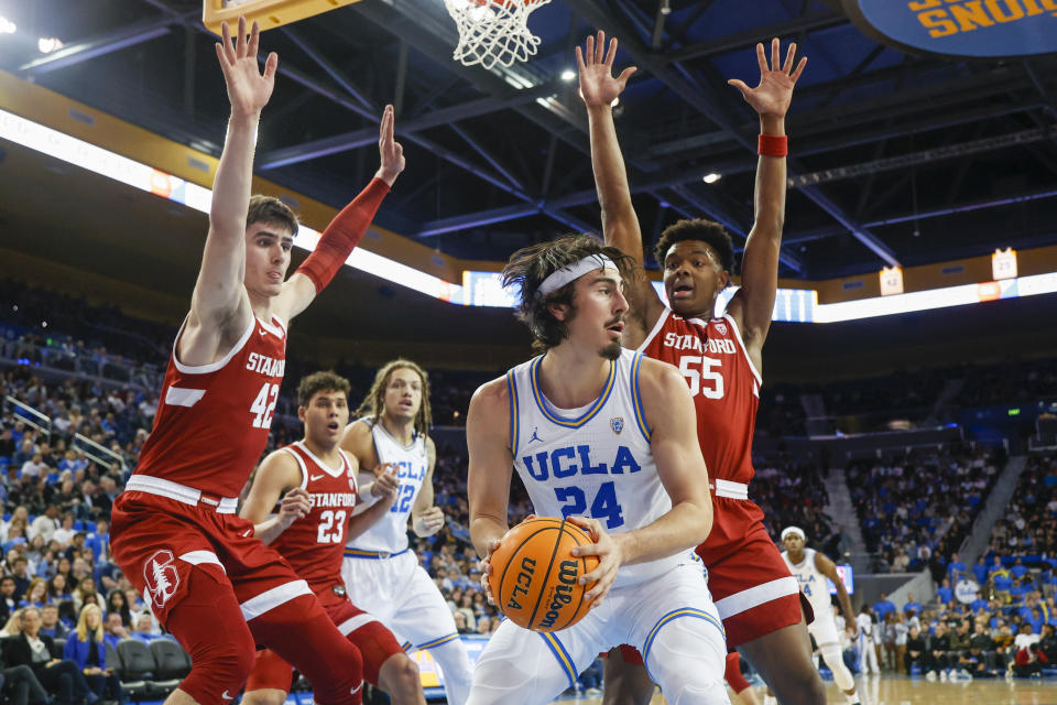 FILE - UCLA guard Jaime Jaquez Jr. (24) is defended by Stanford forwards Maxime Raynaud (42) and Harrison Ingram (55) during the second half of an NCAA college basketball game Thursday, Feb. 16, 2023, in Los Angeles. It has been a great season so far for No. 4 UCLA and Jaime Jaquez Jr. Not only does the senior have a chance at winning Pac-12 Player of the Year honors, but this season has been extra special because his sister Gabriela is in her first year on the Bruins women's basketball team (AP Photo/Ringo H.W. Chiu)