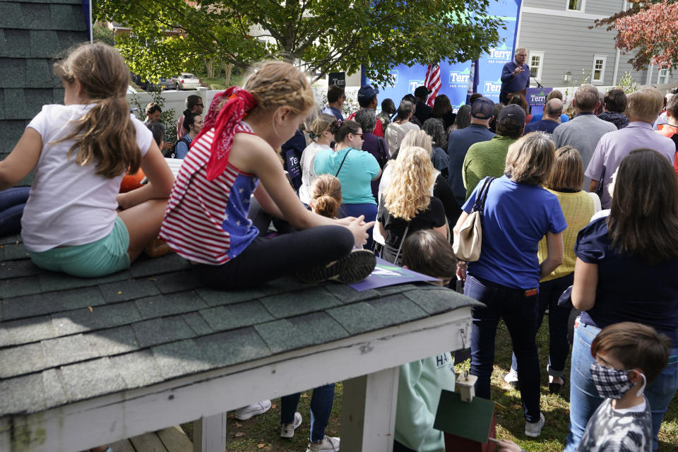 Kids watch the proceedings from the roof of a playhouse as Democratic gubernatorial candidate former Virginia Gov. Terry McAuliffe speaks to supporters during a rally in Richmond, Va., Sunday, Oct. 31, 2021. McAuliffe will face Republican Glenn Youngkin in the November election. (AP Photo/Steve Helber)