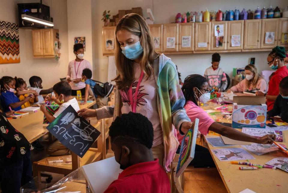 Isabella Dell'Oca, al centro, directora de Lotus Village, observa el trabajo de un joven artista durante una clase dentro del laboratorio de arte y actividades.