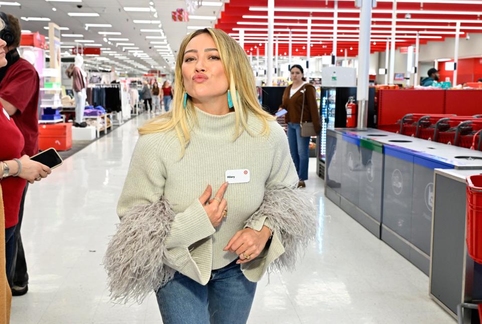 Hilary Duff poses with her nametag as she surprises guests with $500 gift cards at Target on Nov. 16, 2023, in Woodland Hills, California.