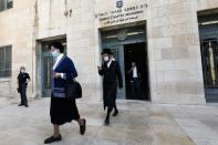 Ultra-Orthodox Jewish people, family members of Malka Leifer, a former Australian school principal accused of sexually assaulting students, walk out of the District Court after a verdict was heard in the extradition case against Leifer, in Jerusalem