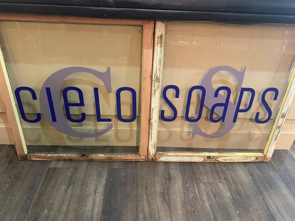 A sign inside of Cielo Soaps and Wine at the Crossing on Monday, February 7, 2022. These windows were part of the original building, which was constructed in 1885.