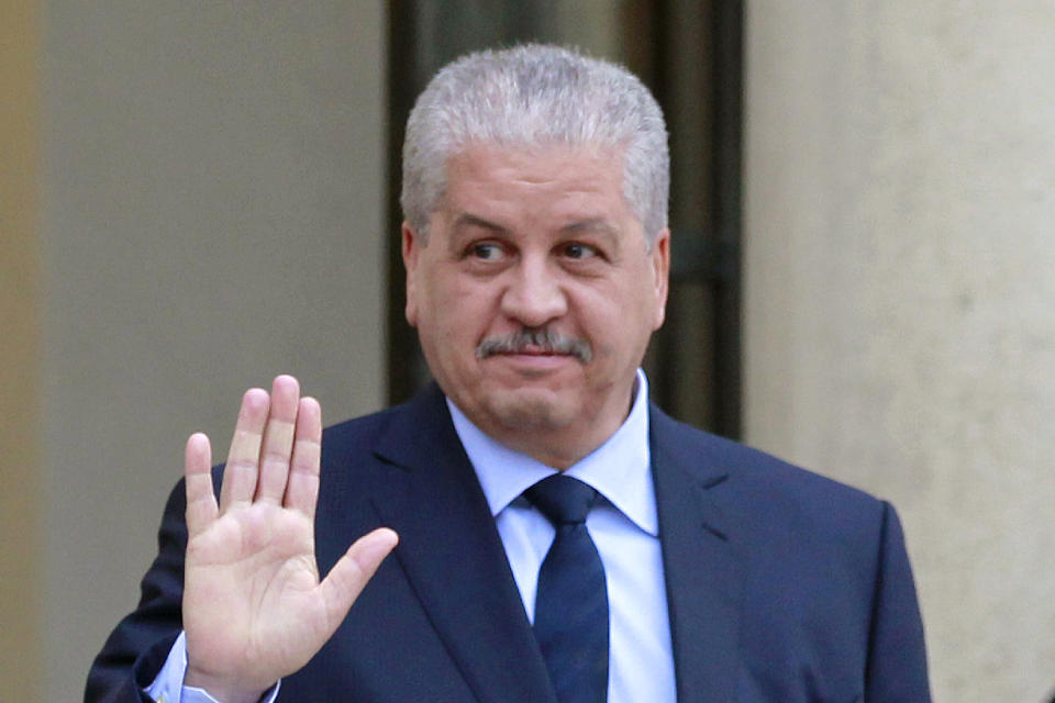 FILE - In this Dec.4, 2014 file photo, former Algerian Prime Minister Abdelmalek Sellal waves to reporters as he leaves the Elysee Palace following his meeting with French President Francois Hollande in Paris. Abdelmalek Sellal was sentenced to 12 years in prison and $8,000 in fines. (AP Photo/Remy de la Mauviniere, File)