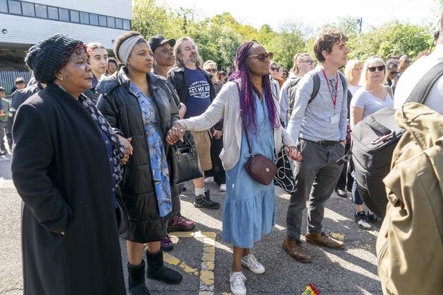 People attend a vigil at Hainault Underground station car park