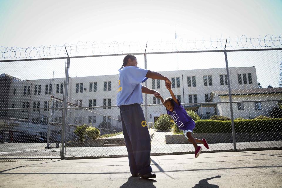 Pharaoh Haywood plays with his daughter during a "Get On the Bus" visiting day to Folsom State Prison