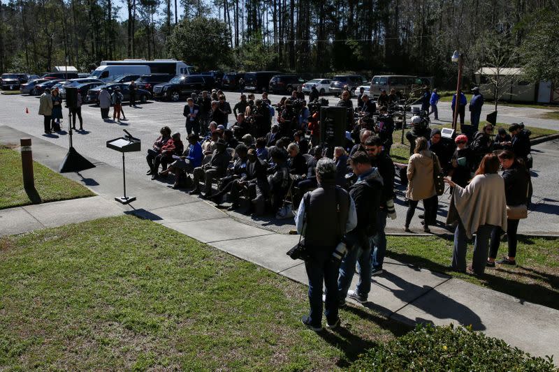 People wait for Democratic U.S. presidential candidate and former U.S. Vice President Joe Biden to make a statement about healthcare outside St. James-Santee Family Health Center in McClellanville