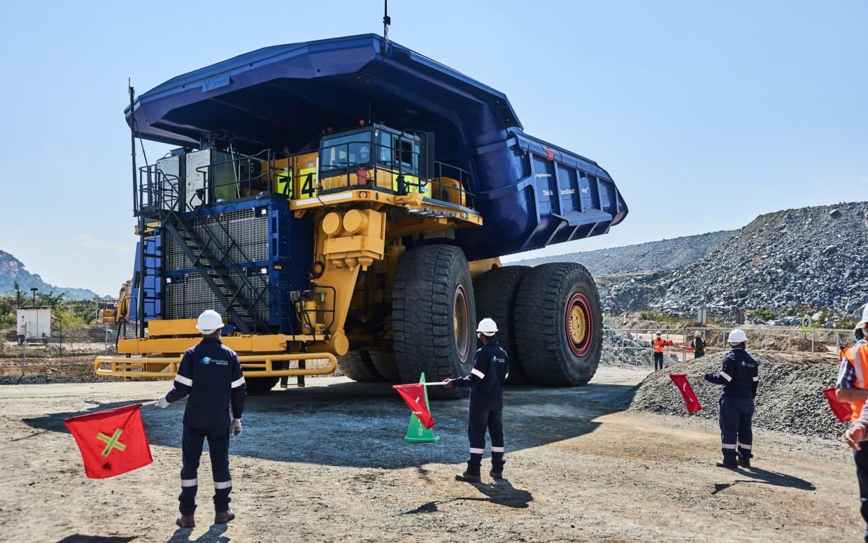 Workers guide a hydrogen-powered truck, part of Anglo American Plc's NuGen carbon-neutral project